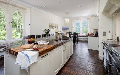 Spacious Kitchen for Corporate Clients - State-of-the-art kitchen equipped with high-spec appliances, a large island and an elegant dining table