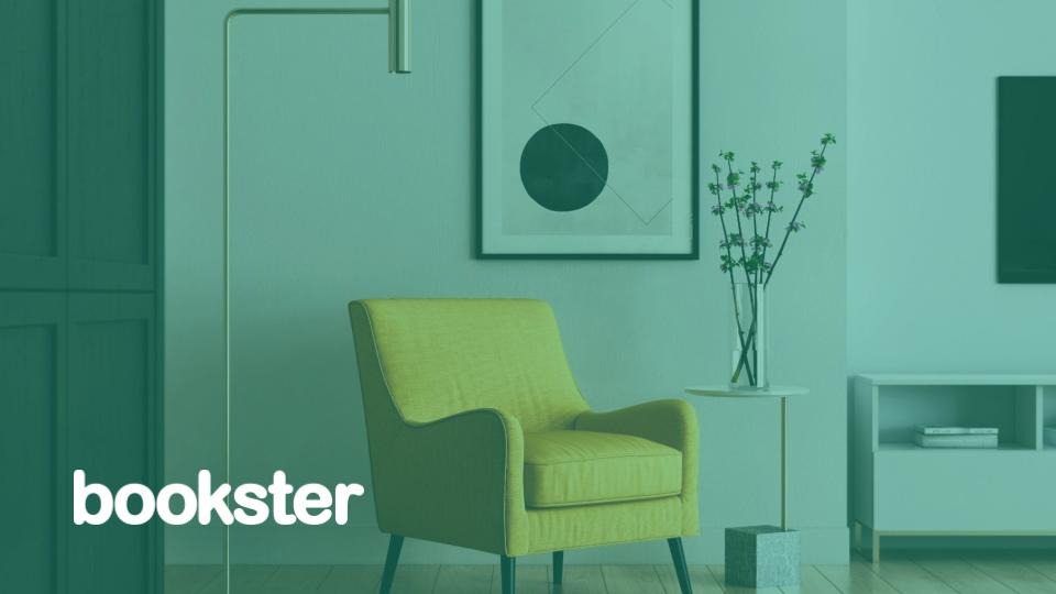 Holiday Let Booking System in the UK - A photo of a living room scene with yellow armchair in front of a wall of modern art, with a Bookster logo. (© Kam Idris on Unsplash)