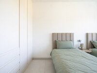 Minimalist bedroom with sage green bedding