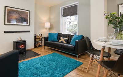 Spacious Lounge in Luxury Holiday Let - Spacious wooden floored sitting and dining room, featuring ample comfy seating and a wood burner Spacious Lounge in Luxury Holiday Let - Spacious wooden floored sitting and dining room, featuring ample comfy seating and a wood burner