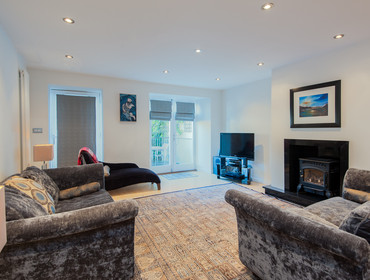 York Place Residence-23 - Spacious family living area with wood burning stove