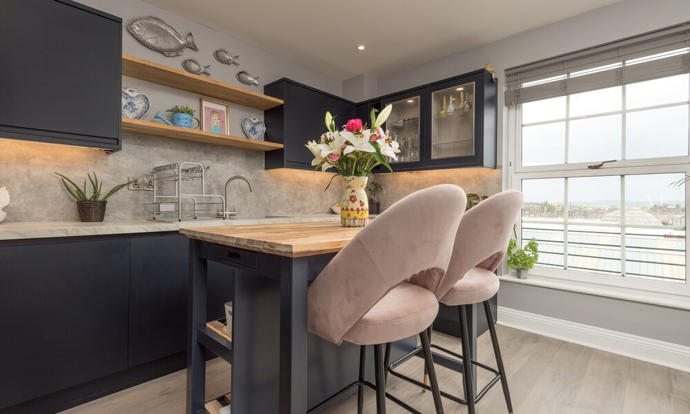 Spacious Kitchen with Views over the Firth of Forth - Natural light floods the kitchen through large north-facing windows, offering beautiful views towards the Firth of Forth. The spacious layout combines luxury finishes with one of Edinburgh's most desirable city-centre locations.