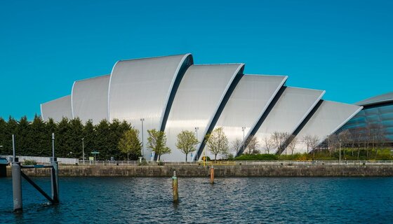 Visit The Armadillo in Glasgow - A large segmented silver building next to a body of water. (© Brian Aitkenhead @ Unsplash) Visit The Armadillo in Glasgow - A large segmented silver building next to a body of water. (© Brian Aitkenhead @ Unsplash)