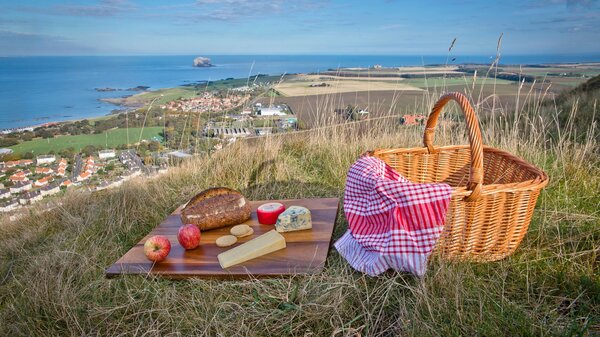 Picnic on Berwick Law - A picnic basket and rug on Berwick Law, overlooking the Firth of Forth (© Visit Scotland)