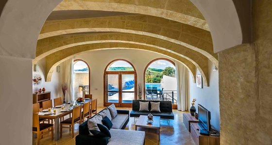 Lounge pool view in villa in Gozo - Open space dining area and living room