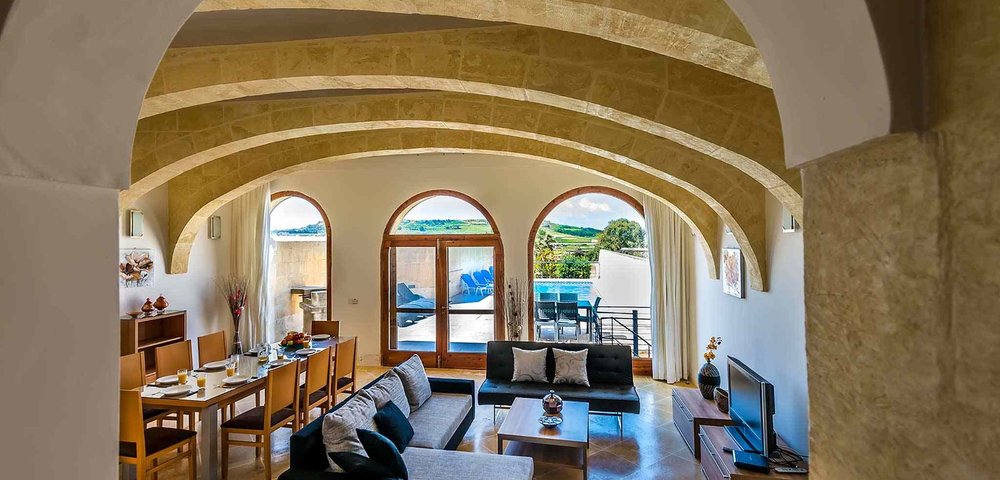 Lounge pool view in villa in Gozo - Open space dining area and living room