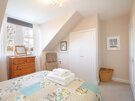 Double bedroom - Bright double bedroom with comfortable chair and ample storage
