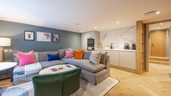 260e0f71-6160-49bf-bbc6-af1100db932a - Superb open-plan living room and a fully equipped kitchen with a clean, contemporary design.
