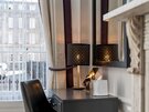 Bedroom Vanity Desk in a Holiday Home - Dark grey vanity desk paired with a black leather chair, a decorative patterned lamp, and a large wall mirror