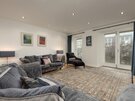 Living Room - Stylish living room with patio doors to outside decking area of Edinburgh self-catering holiday accommodation.