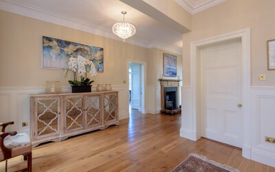 Open hallway in St Aidans, North Berwick rental home - Large hallway featuring fireplace and sideboard