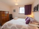 Master Bedroom - Double bedroom featuring a stylish solid wooden cabinet and king size bed in Edinburgh holiday apartment.