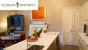 Case Study of The Georgian Apartment - View from the kitchen to the dining area with a large kitchen island. Case Study of The Georgian Apartment - View from the kitchen to the dining area with a large kitchen island.