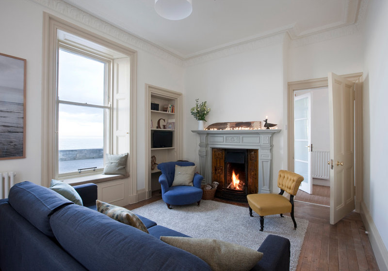 Seaside pet friendly apartment - Living room with open fire and sea views. Seaside pet friendly apartment - Living room with open fire and sea views.