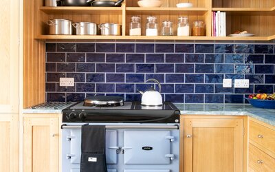 Kitchen in a Self-Catered Cottage - Kitchen with a pop of navy blue. Vintage AGA stove that will make your cooking sessions memorable