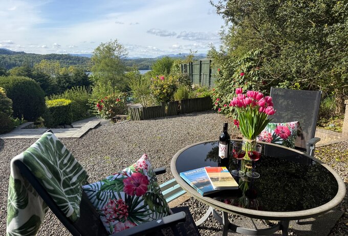 Larchside-patio - Table and chairs on private patio with countryside and views of lake Windermere (© Windermere Staus)