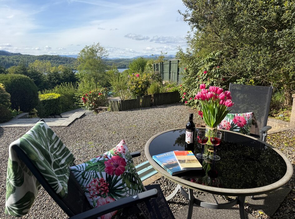 Larchside-patio - Table and chairs on private patio with countryside and views of lake Windermere (© Windermere Staus)