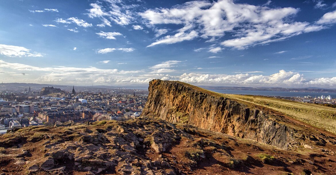 Edinburgh short breaks - View over Salisbury Crags and Edinburgh city. (© Yves Alarie on Unsplash)