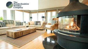 Client spotlight reviews Case Study (6) - Photo of a fire in a living room with large sofa.