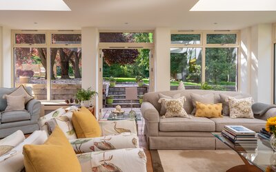 Bright Orangery in a Holiday Let in Scotland - The Orangery - featuring comfortable sofas, an elegant table and stunning views