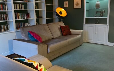 TV Lounge in a Holiday Stay in Perth and Kinross - Spacious comfy seating featuring stylish décor and bookshelves across 1 wall