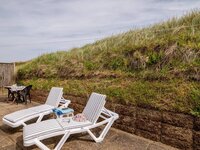 Sunbeds on a sunny patio with striped cushions