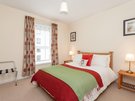 Holyrood Road 5 - Double bedroom with decorative owl cushion and plentiful guest storage