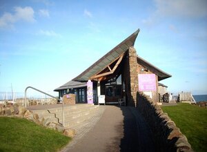 The Scottish Seabird Centre in East Lothian, Scotland - Image of The Scottish Seabird Centre building along a path. (© james denham, CC BY-SA 2.0 <https://creativecommons.org/licenses/by-sa/2.0>, via Wikimedia Commons)