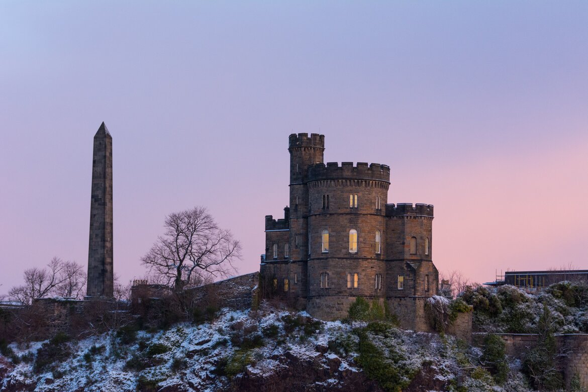 Edinburgh in December - A view of Nelson Monument at Calton Hill in Edinburgh in the snow at sunset.
