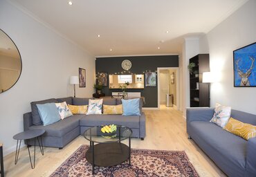 Living room/dining area. - Contemporary living room and dining area, with two grey sofas in Dean Village holiday home.