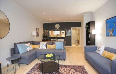 Living room/dining area. - Contemporary living room and dining area, with two grey sofas in Dean Village holiday home.