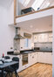 Fully fitted kitchen and dining table with mezzanine gallery above