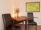 Living Room - Wooden dining table and leather chairs in Edinburgh holiday rental.