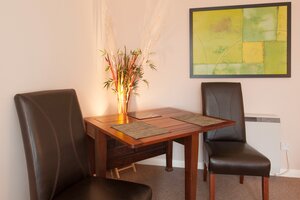 Living Room - Wooden dining table and leather chairs in Edinburgh holiday rental.