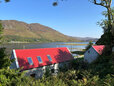 Looking over the cottages to the sea and mountains