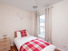 The Park (Holyrood Road) 6 - Single bedroom with stag wall feature and tartan throw and cushion