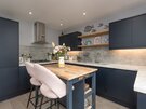 Designer Kitchen with Integrated Appliances - This beautifully designed kitchen showcases integrated appliances, contemporary cabinetry, spacious worktops and a central island, creating a practical yet elegant heart of the apartment.