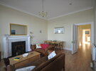 Seafront 2 bedroom self catering with sea views - Simple and very comfortable lounge and dining room with large bay windows