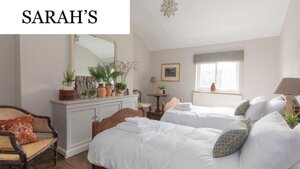Case Study of Sarah's short stay apartment - Twin bedroom with light walls and two beds.