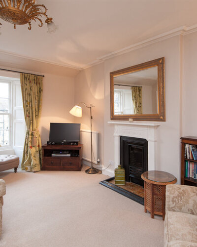 Hart Street Apartment-16 - Family living room with large wall mirror and TV in luxury Edinburgh holiday let