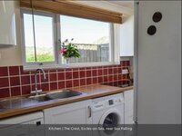 Kitchen with red tiles well equipped kitchen