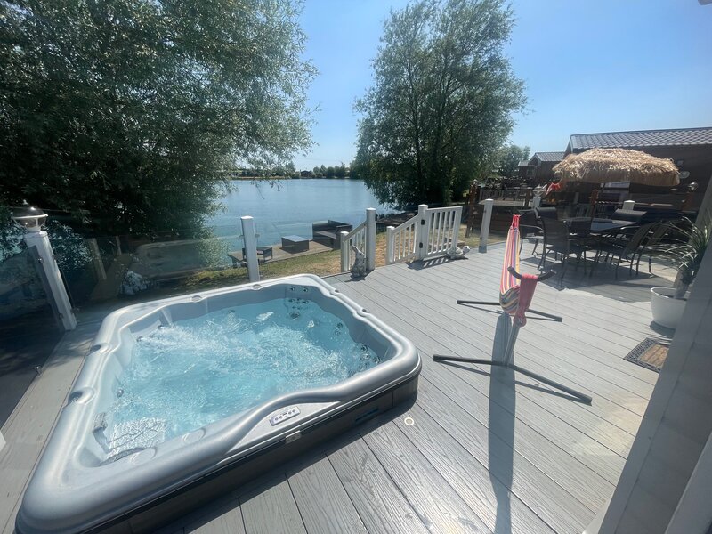 lake view with hot tub, fishing peg