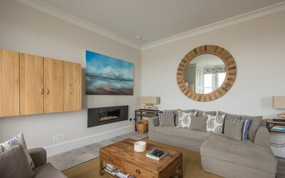 Sitting room, The Beach House - Grey plush furnishing and a feature flame effect gas fire in North Berwick holiday home.