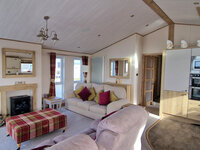 Lounge with TV and Fireplace and Kitchen