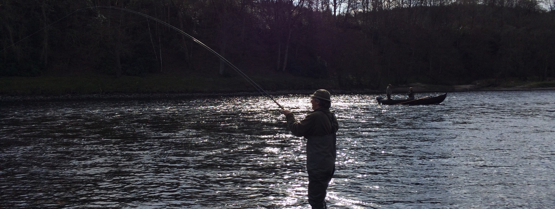 Playing a fish in The Burn - Playing a salmon on the River Tay on Murthly Beat 1 Beat 2 in the low spring sunshine (© Murthly Estate)