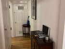 Furniture in hallway of The Lothian Road Residence - Wooden flooring through the open hallway to two of the double bedrooms.