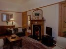 Living Room - The living room exudes classic charm with wooden features and a focal fireplace, which is not available for guest use for guest and property safety. (© The Edinburgh Address)